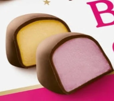 Boules crème chocolat noir fourrées saveur orange, framboise et vanille (100g)